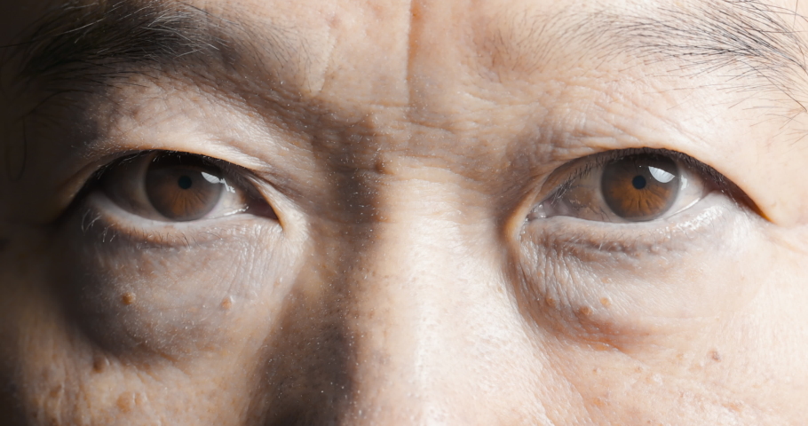 Slow motion of macro shot elderly man two brown eyes with pupil and iris | Shutterstock HD Video #1061923711