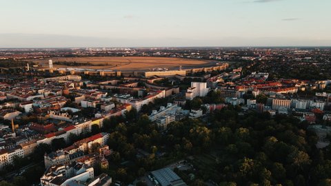 Tempelhofer Feld in Berlin, Sunset over the Skyline of Berlin, aerial drone shot from above of the capital city of Germany, birds eye view, metropole town