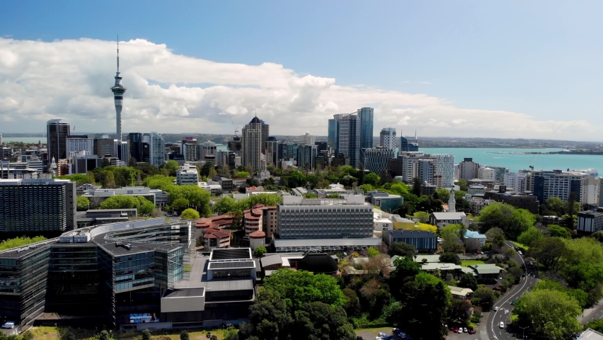 Auckland CBD aerial cityscape of Sky Tower, skycrapers and city parks. Sunny day, in a large metropolitan city. New Zealand Royalty-Free Stock Footage #1061935060