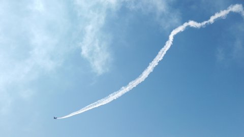 Vintage biplane does loop stunt with smoke trails. airplane air show 4k 