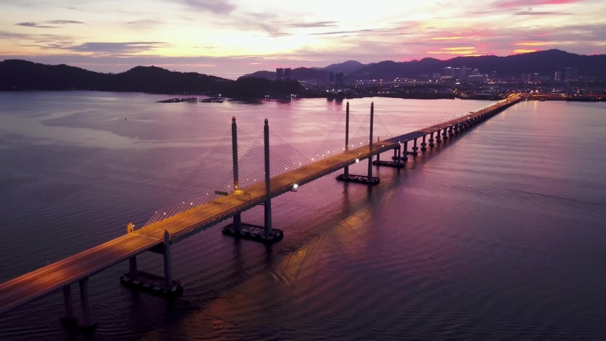 Aerial dramatic highway light of Penang Second Bridge with dramatic twilight sunset colorful sky.