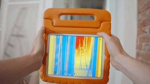 Close up of person detecting heat loss inside house using infrared thermal camera. Builder or foreman using digital tablet checking apartment insulation during renovation