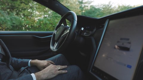 Modern car driving on autopilot. Autopilot in car. Intelligent vehicle driveless automobile concept. Hands free system. Vehicle autonomous self-driving.