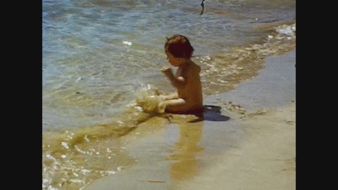 LA VALLETTA, MALTA 1981: Baby have fun in holiday at the beach, 4k Digitized Footage