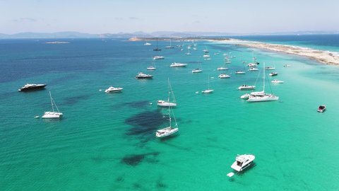 Yachting in the Balearic islands around Ibiza. Aerial View of many yachts in a bay on Formentera island.