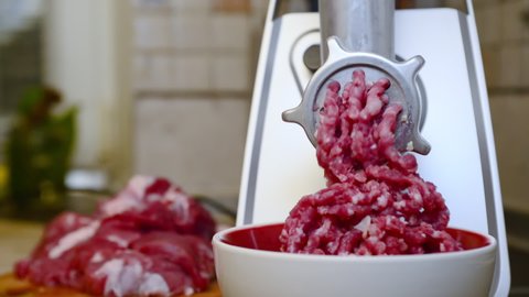Electric meat grinder. Making minced meat in an electric meat grinder from fresh meat at home