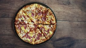 Grabbing a Slice of Hawaiian Pizza with Ham and Pineapple