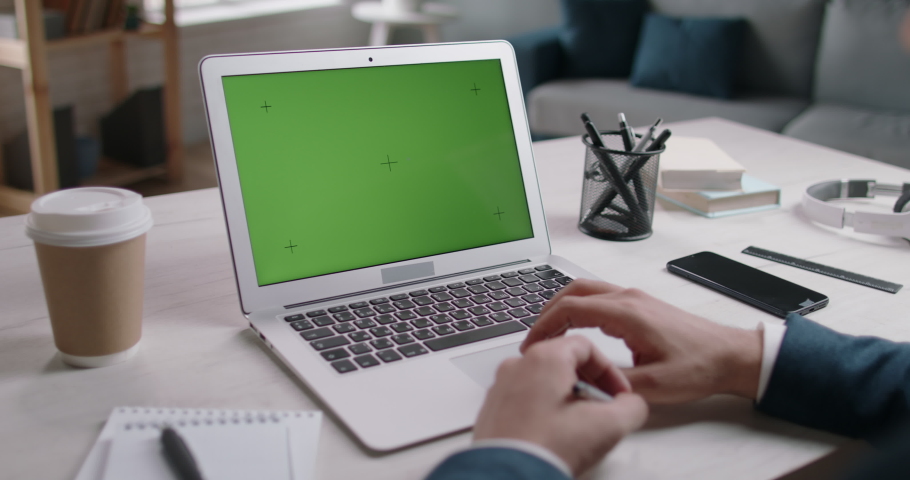 Businessman having a video conference with team. Employee at video chat talking and gesturing. Template of green chroma key laptop screen 4k footage Royalty-Free Stock Footage #1061969440