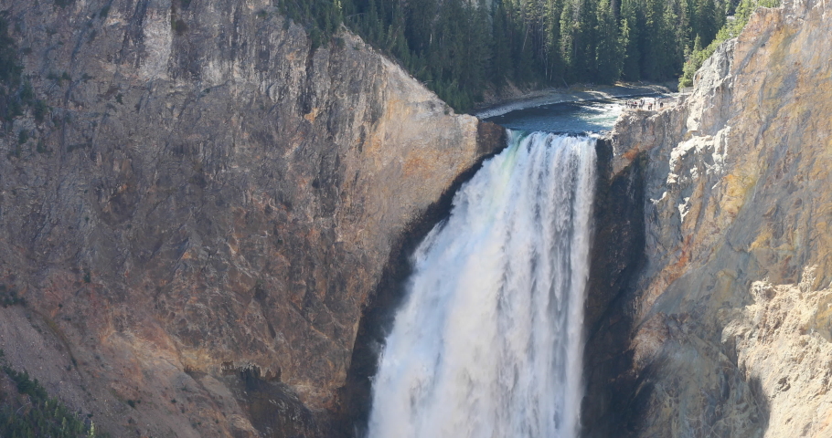Yellowstone Lower Falls close to lookout people at brink 4K. Geyser Yellowstone in Wyoming, Montana and Idaho, USA. Geothermal geological environment ecosystem landscape. Biology geography and ecology
