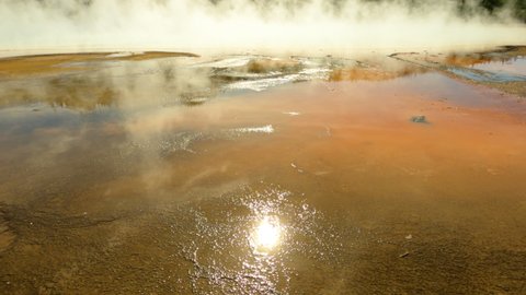 YELLOWSTONE, WYOMING - 22 SEPT 2020: Yellowstone geyser pool landscape steam walking 4K. Geyser geology. Wyoming, Montana and Idaho, USA. Geothermal geological environment ecosystem landscape.