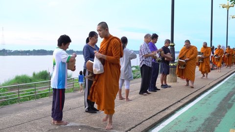 Nakhon Phanom, Thailand- Oct 10, 2020: Thai people made merit by giving food to monk in the morning