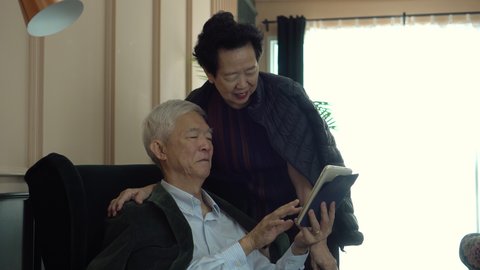 Wealthy rich Asian elder senior couple with technology aging society