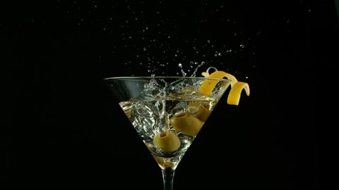 Super Slow motion shot of olives splashing into Dry Martini Drink, 1000 fps