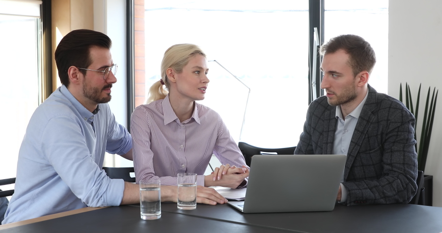 Happy young caucasian family couple consulting with financial advisor about savings investment. Confident male lawyer showing services presentation on computer to clients at modern workplace. Royalty-Free Stock Footage #1061991967