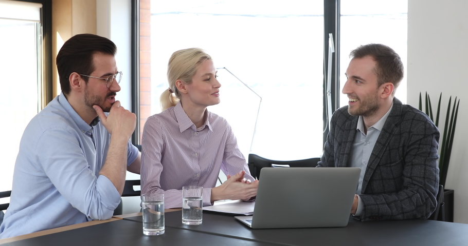 Happy young caucasian family couple consulting with financial advisor about savings investment. Confident male lawyer showing services presentation on computer to clients at modern workplace. | Shutterstock HD Video #1061991967