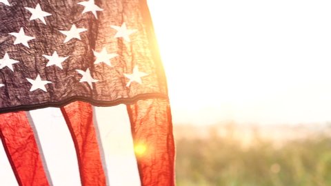 Close up American flag waving on sunset with soft focus, Slow Motion. Concept of Memorial Day or 4th of July, Independence Day, Veterans Day, Celebrate USA, American Election. America Concept.