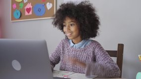Smart happy african child kid girl waving raising hand talking with remote web teacher on social distance video conference call elearning class on computer. Children virtual learning at home concept - Powered by Shutterstock - Get 15% off with code: PIKWIZARD15