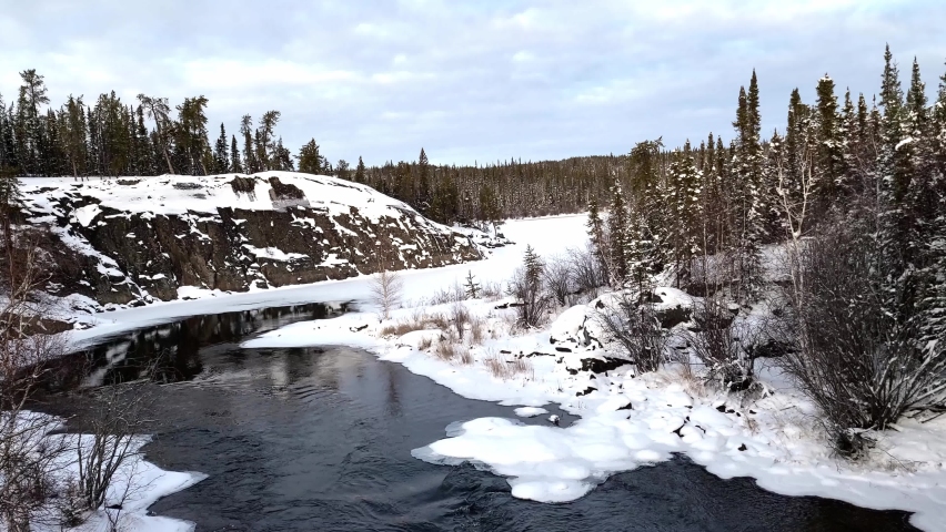 4K video of a flowing near Cameron river falls in the winter time, 