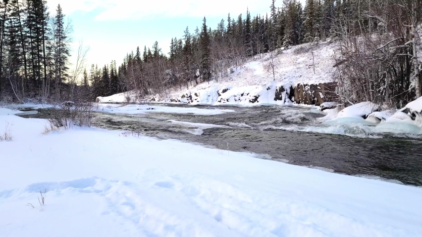 4K video of a flowing near Cameron river falls in the winter time, 