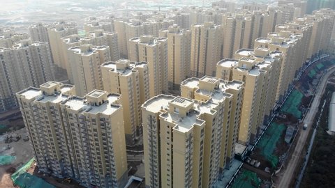 Aerial of new apartment building complex in China. Drone shot of Asian newly constructed residential towers in Xichang. Real estate development in dense populous city.