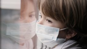 Little Child Boy With Protective Mask, Sad Looking Through Window Worried About Covid-19 Lockdown. Kid In Protection Mask Looking Out Window Home. Quarantine Coronavirus Social Distancing - Powered by Shutterstock - Get 15% off with code: PIKWIZARD15