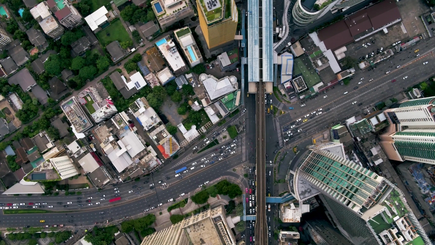 AERIAL: Drones fly forward high north, split into the streets of densely populated Bangkok city. Stunning top-down shots at sunrise. Royalty-Free Stock Footage #1062024517