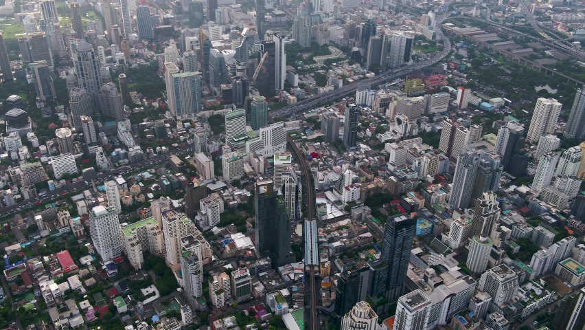 Bangkok, Thailand, flies low between skyscrapers above Wattana District to Makkasan District with city views. Royalty-Free Stock Footage #1062024526