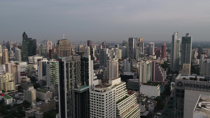 Bangkok, Thailand, flying low between skyscrapers above Bangkok with city views. Royalty-Free Stock Footage #1062024754