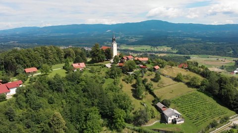 Aerial view of a church in a small village on top of a hill in southeast Slovenia