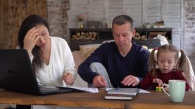 The family financial crisis, unemployment, joblessness, business problems during Covid-19. Worried mother father and child at home. Coronavirus, Quarantine, Social Distancing, Self-Isolation, Lockdown - Powered by Shutterstock - Get 15% off with code: PIKWIZARD15