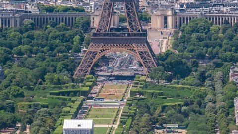 Aerial view from Montparnasse tower with Eiffel tower and Champ de Mars timelapse in Paris, France. Top view from observation deck at sunny summer day.
