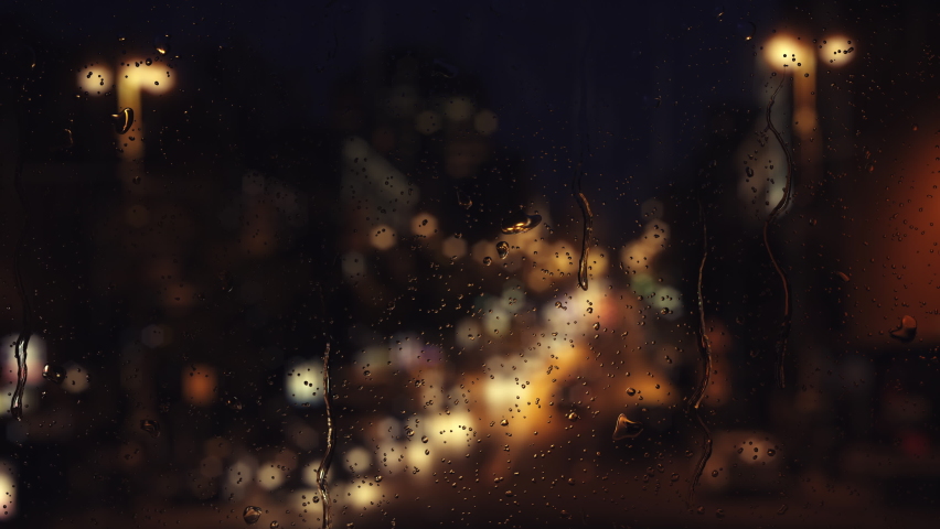 Falling rain drops on window surface. 4K loop video animation. Night city and landscape with street lights. Flowing water drops on blurry glass.