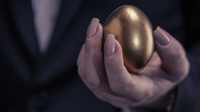golden chicken egg in female hand,business concept - Powered by Shutterstock - Get 15% off with code: PIKWIZARD15