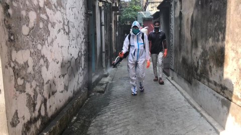 KOLKATA /INDIA - OCT 2020 : A man spraying disinfectant in the road in Kolkata for protecting from Corona virus