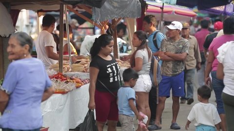 Lima, Peru – April 15, 2019. peru market. many people walk between the rows with meat and bananas and fruits. eating street food. sellers in the market. Peruvian, traditional, exotic market
