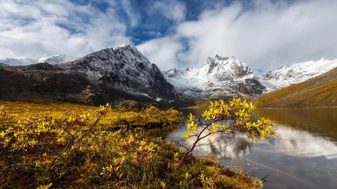 Cinemagraph Continuous Loop Animation. View of Scenic Alpine Lake, Rocks and Snowy Mountains in Canadian Nature. Season change Fall to Winter. Grizzly Lake, Tombstone Territorial Park, Yukon, Canada.