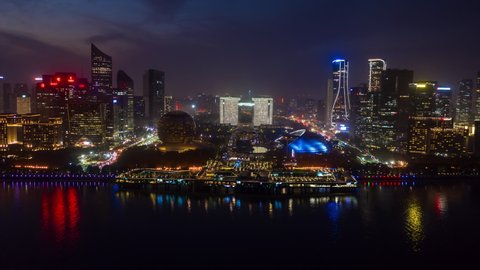 night time hangzhou city famous modern riverside bay downtown pedestrian streets aerial timelapse panorama 4k china