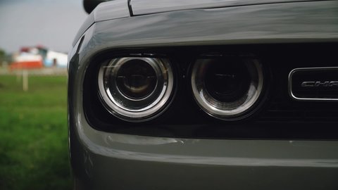 UKRAINE - 2020 :  the car dodge challenger flashes its headlights. Cool footage with muscle car