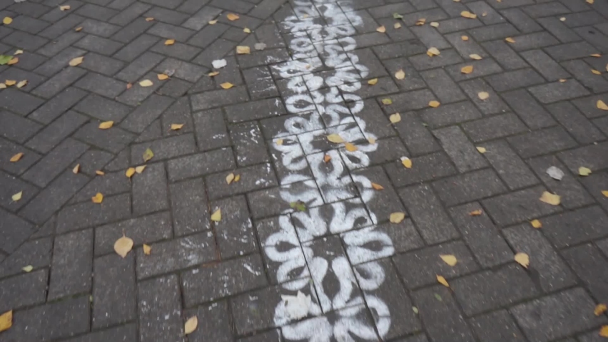 a path of patterns drawn in white paint on the road