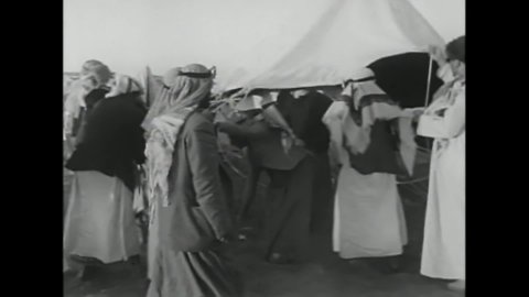 CIRCA 1960s - Arabs set up tents, prepare food, and sing and dance into the evening with a Sheikh among them in 1967.