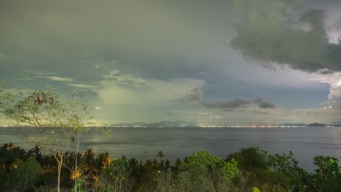4k night to day timelapse with thunderstorms passing by and bright stars rotating over Bali, Indonesia