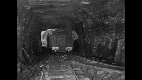 CIRCA 1920s - Coalminers underground transporting coal in railcars, Pocahontas, West Virginia in the 1920s.