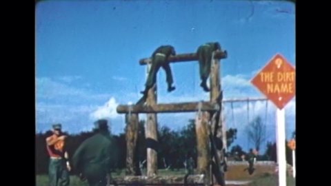 CIRCA 1970 - Marine Corps recruits go through confidence course training, and then head off to Elliotts Beach for a hike and overnight stay.