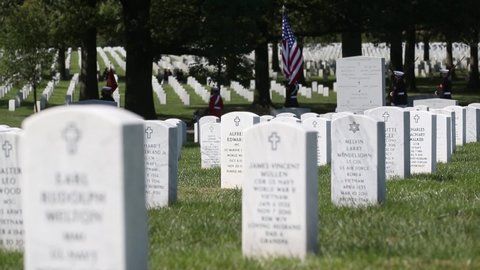 CIRCA 2020 U.S. Marines in dress uniform lay a fallen soldier to rest at Arlington National Cemetery, Washington.