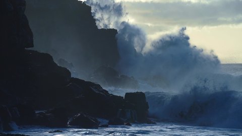 CIRCA 2020 - Extreme slow motion of beautiful ocean waves crashing into Kaiaka Rock, Molokai Hawaii suggests refreshment, beauty, and nature.