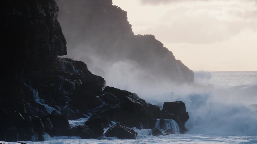CIRCA 2020 - Extreme slow motion of beautiful ocean waves crashing into Kaiaka Rock, Molokai Hawaii suggests refreshment, beauty, and nature. Royalty-Free Stock Footage #1062068698