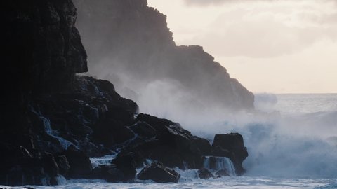 CIRCA 2020 - Extreme slow motion of beautiful ocean waves crashing into Kaiaka Rock, Molokai Hawaii suggests refreshment, beauty, and nature.