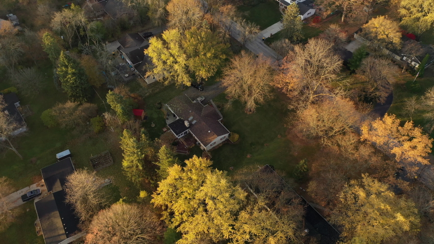 Aerial drone view of American suburban neighborhood. Establishing shot of suburb. Residential single family houses in Autumn Winter season Royalty-Free Stock Footage #1062069988