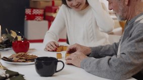 Young woman with grandfather indoors at home at Christmas, playing board games. - Powered by Shutterstock - Get 15% off with code: PIKWIZARD15