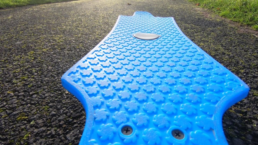 Penny board plastic deck with a man shoes riding it, pov shot